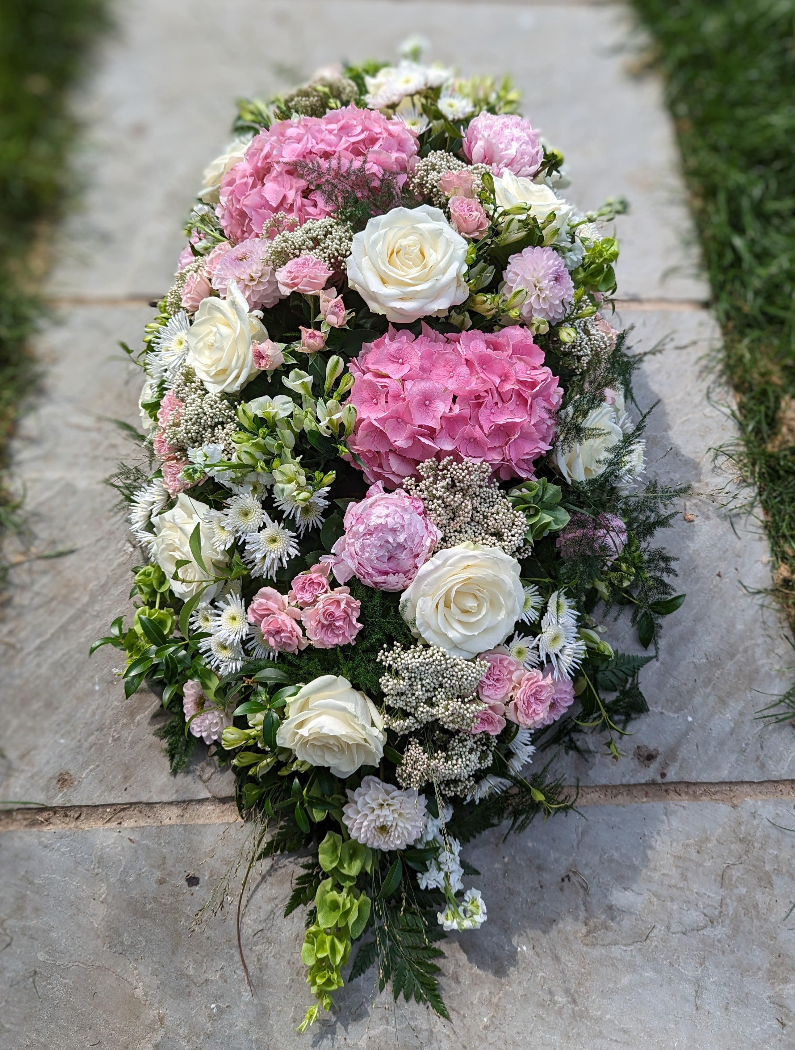 Pink and white casket spray